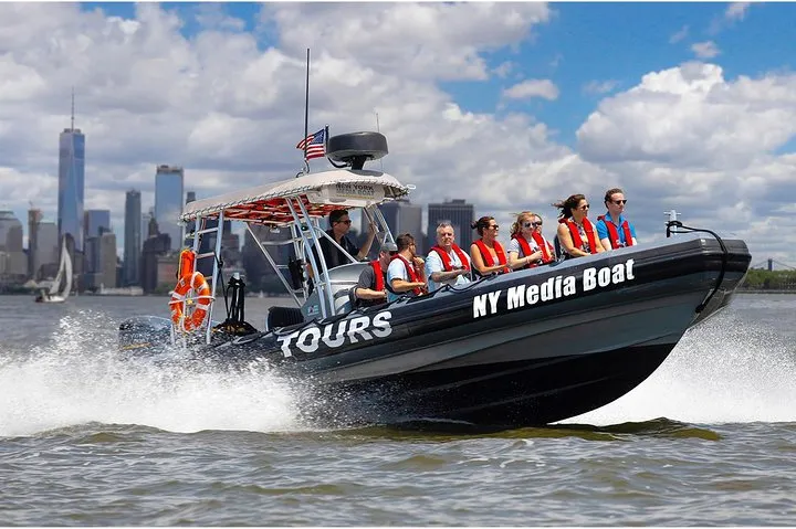 Small media boat on a New York architecture boat tour with the Manhattan skyline behind it
