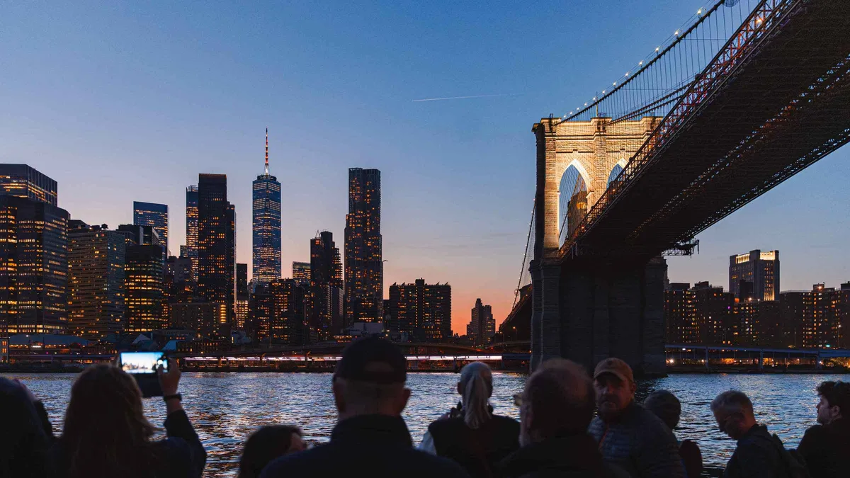 Manhattan skyline lit up at dusk on an evening New York architecture boat tour with Circle Line