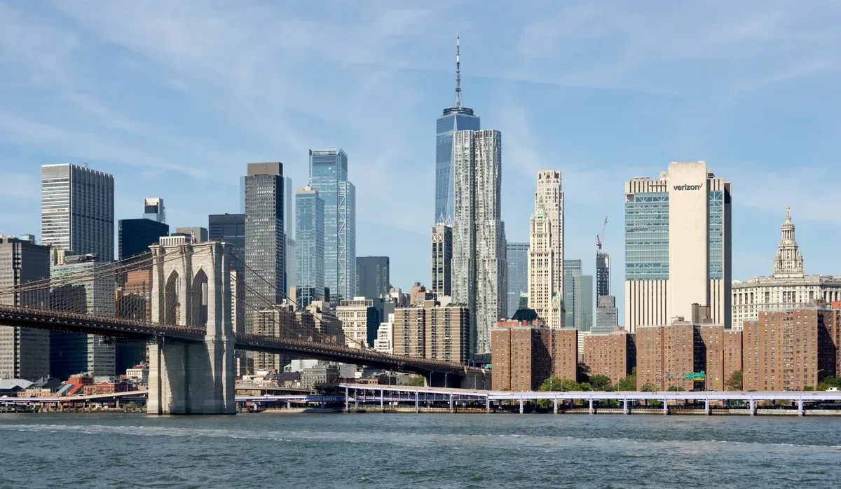 The Brooklyn Bridge and Lower Manhattan with One World Trade Center, seen from an NYC Ferry on the East River, seen on a New York architecture boat tour