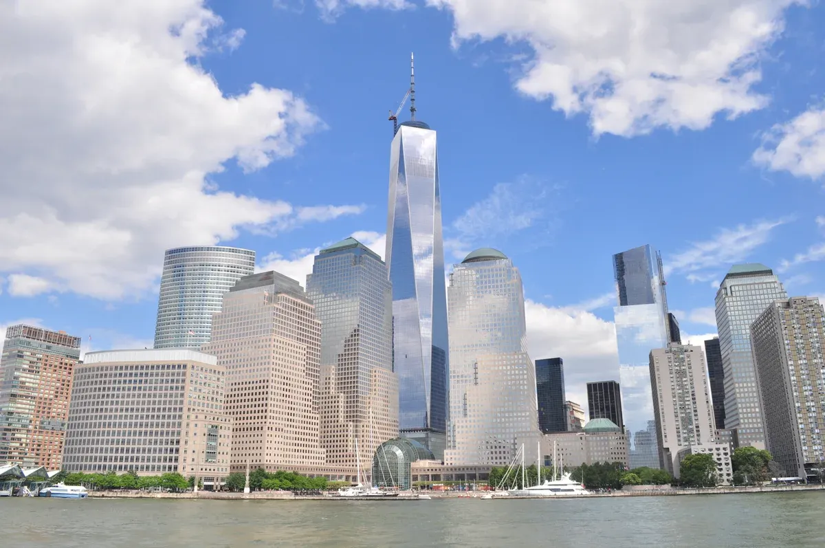 One World Trade Center and the other Lower Manhattan towers seen across New York Harbor from a water taxi under a blue sky, seen on a New York architecture boat tour