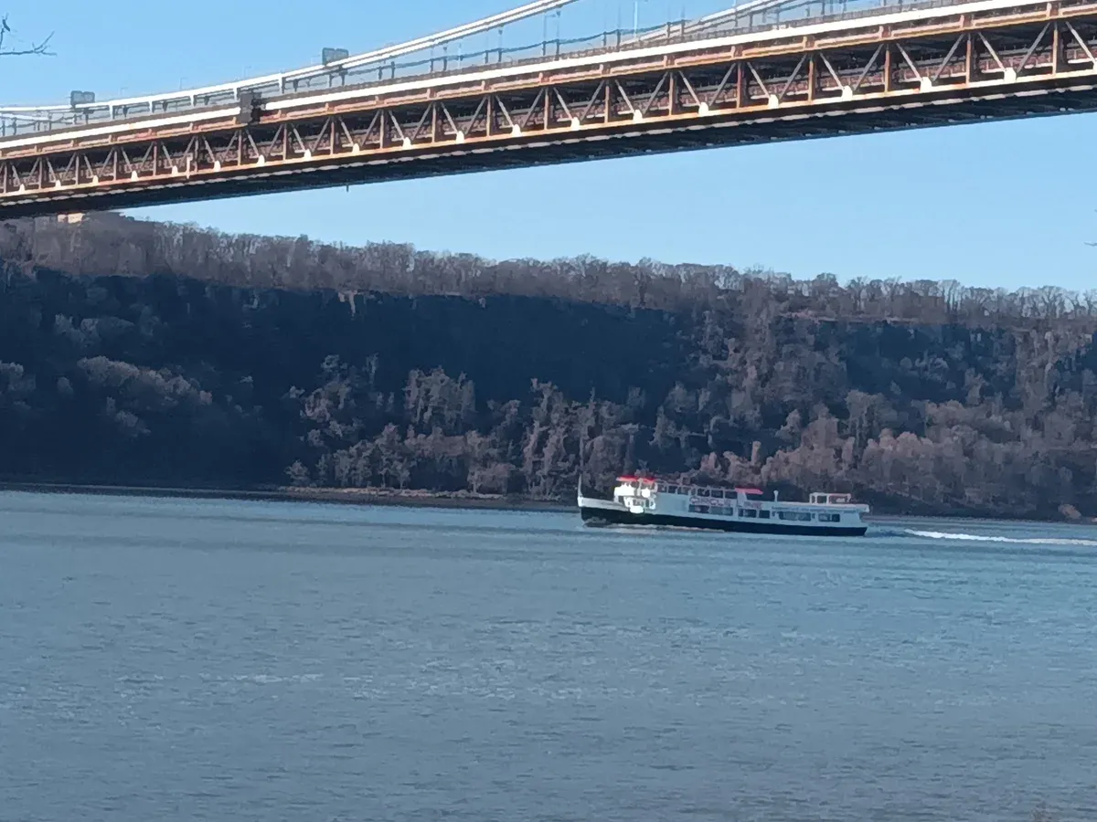 Circle Line vessel on the Hudson River under the George Washington Bridge on an architecture boat tour in New York