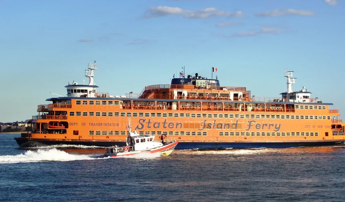 Orange Staten Island Ferry boat in New York Harbor, a free alternative to a paid New York architecture boat tour